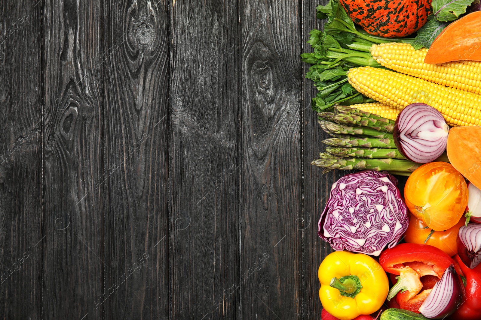 Photo of Flat lay composition with fresh vegetables and space for text on wooden background