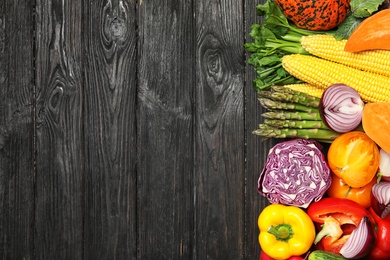 Photo of Flat lay composition with fresh vegetables and space for text on wooden background