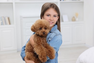 Photo of Little child with cute puppy at home. Lovely pet