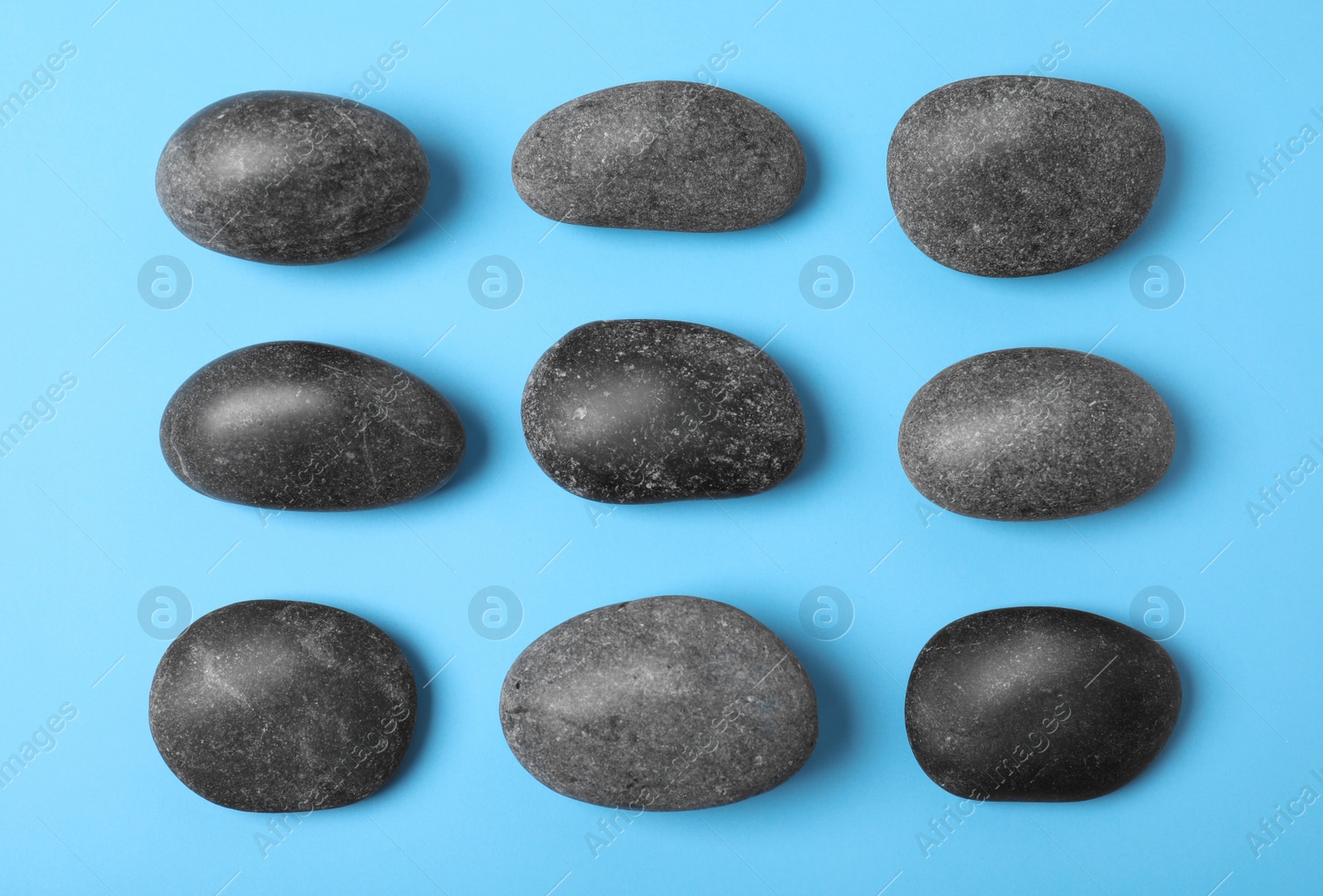 Photo of Spa stones on color background, flat lay