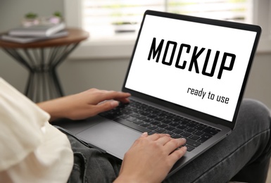 Image of Woman working via modern laptop with text Mockup Ready To Use on screen, closeup