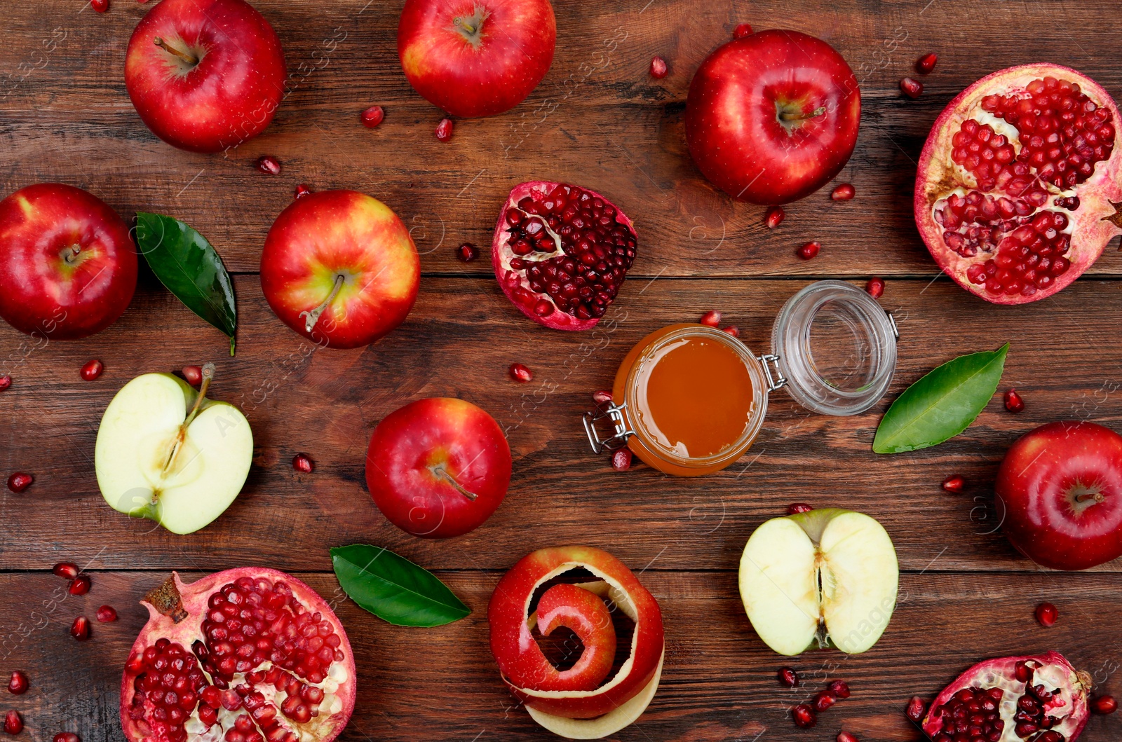 Photo of Honey, apples and pomegranate on wooden table, flat lay. Rosh Hashanah holiday