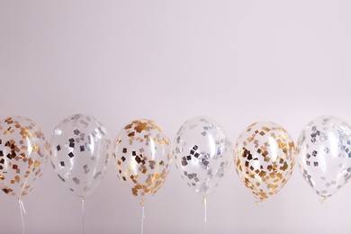 Photo of Color balloons with ribbons on white background