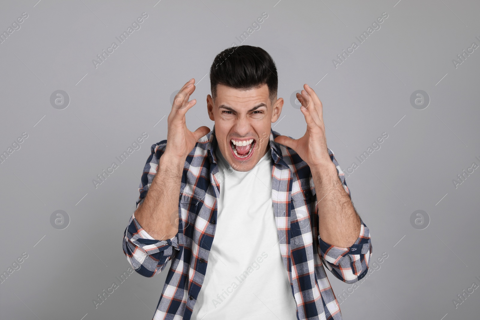 Photo of Portrait of emotional man on light grey background. Personality concept