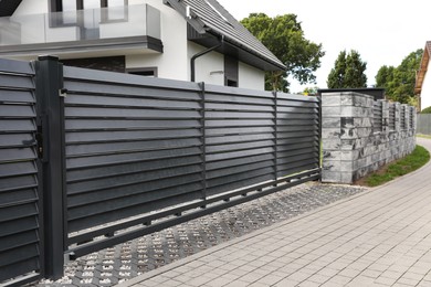 Metal gates near marble columns and house outdoors