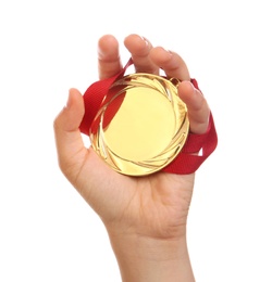 Woman holding gold medal on white background, closeup