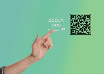 Woman pointing at illustration of QR code on color background, closeup