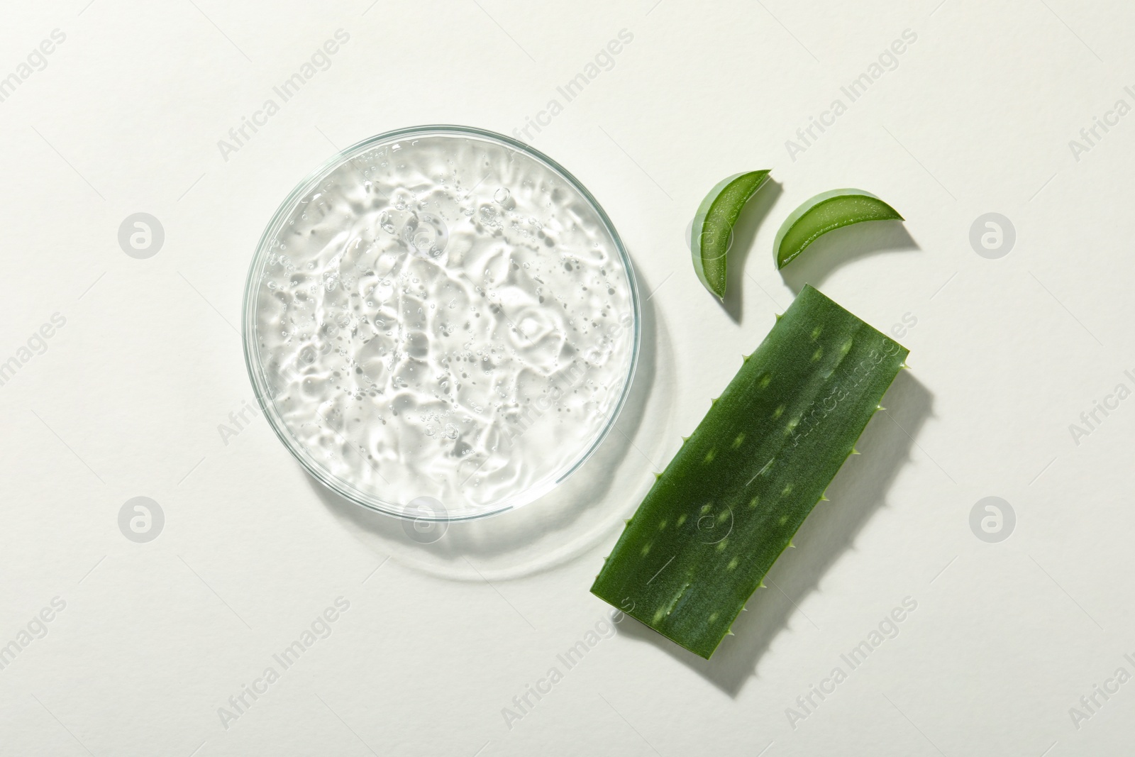 Photo of Cosmetic gel and aloe on white background, flat lay