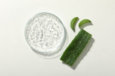 Cosmetic gel and aloe on white background, flat lay