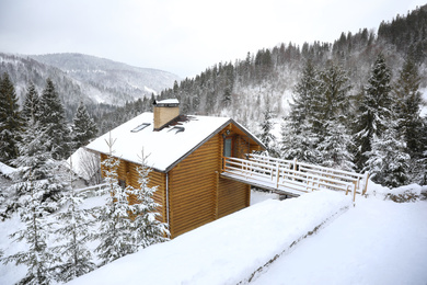 Beautiful landscape with cottage on snowy winter day