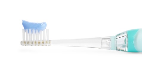 Electric toothbrush with paste on white background, closeup