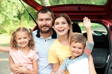 Happy family with children near car, outdoors. Taking road trip together