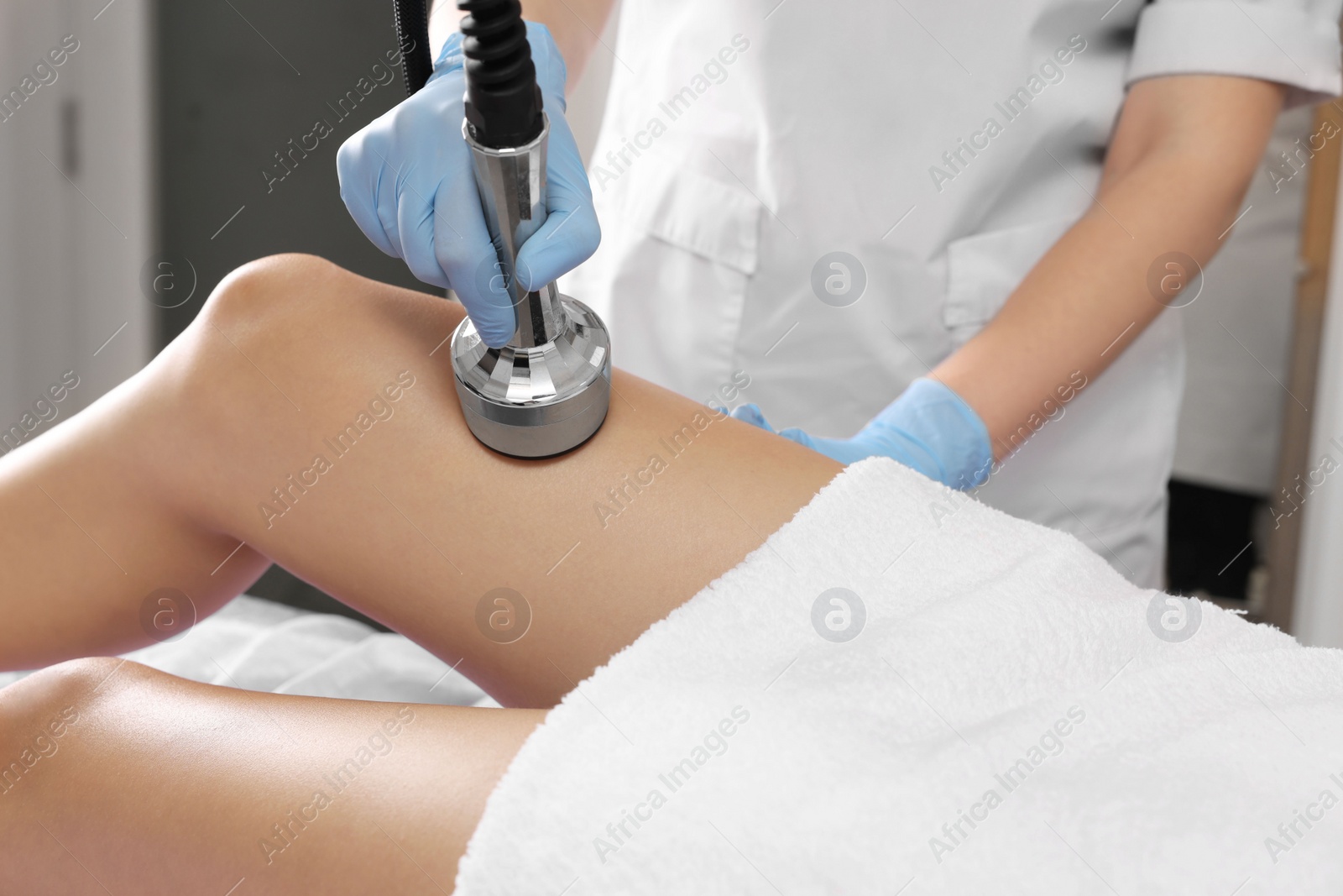 Photo of Woman undergoing radio frequency lifting procedure in beauty salon, closeup