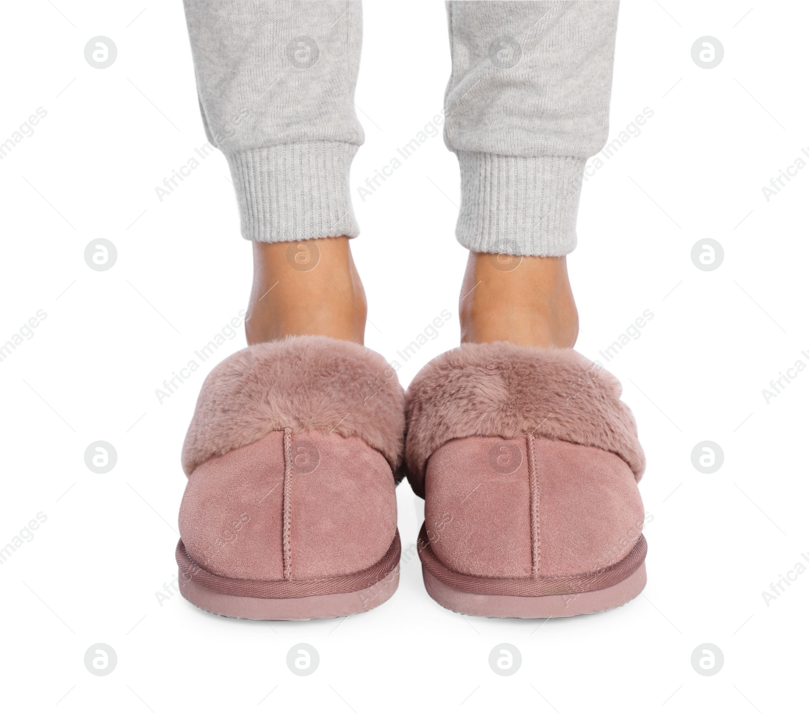 Photo of Woman in warm soft slippers on white background, closeup