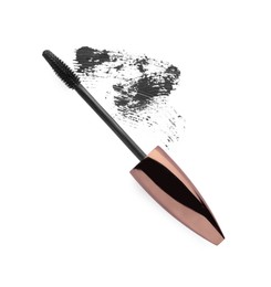 Applicator and black mascara smear on white background, top view