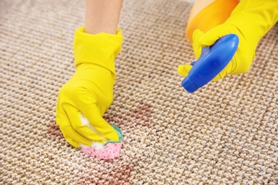 Woman cleaning carpet, closeup