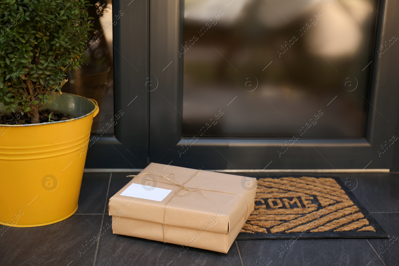 Photo of Delivered parcel on door mat near entrance