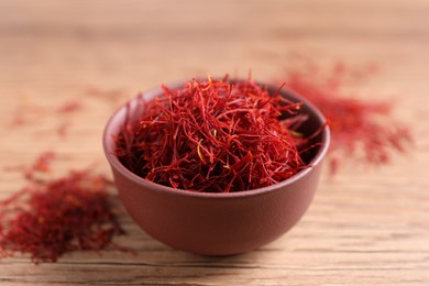 Photo of Dried saffron on wooden table, closeup view