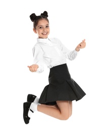 Photo of Happy girl in school uniform jumping on white background