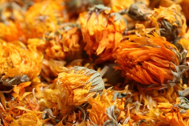 Pile of dry calendula flowers as background, closeup