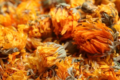 Photo of Pile of dry calendula flowers as background, closeup