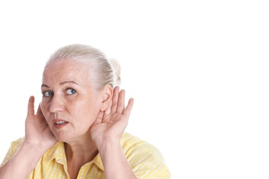 Mature woman with hearing problem on white background