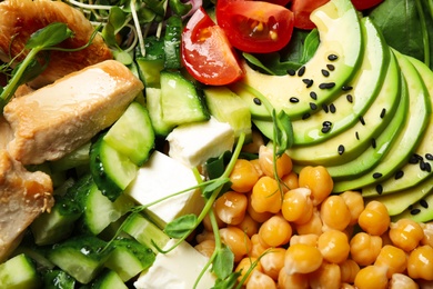 Photo of Delicious avocado salad with chickpea as background, closeup