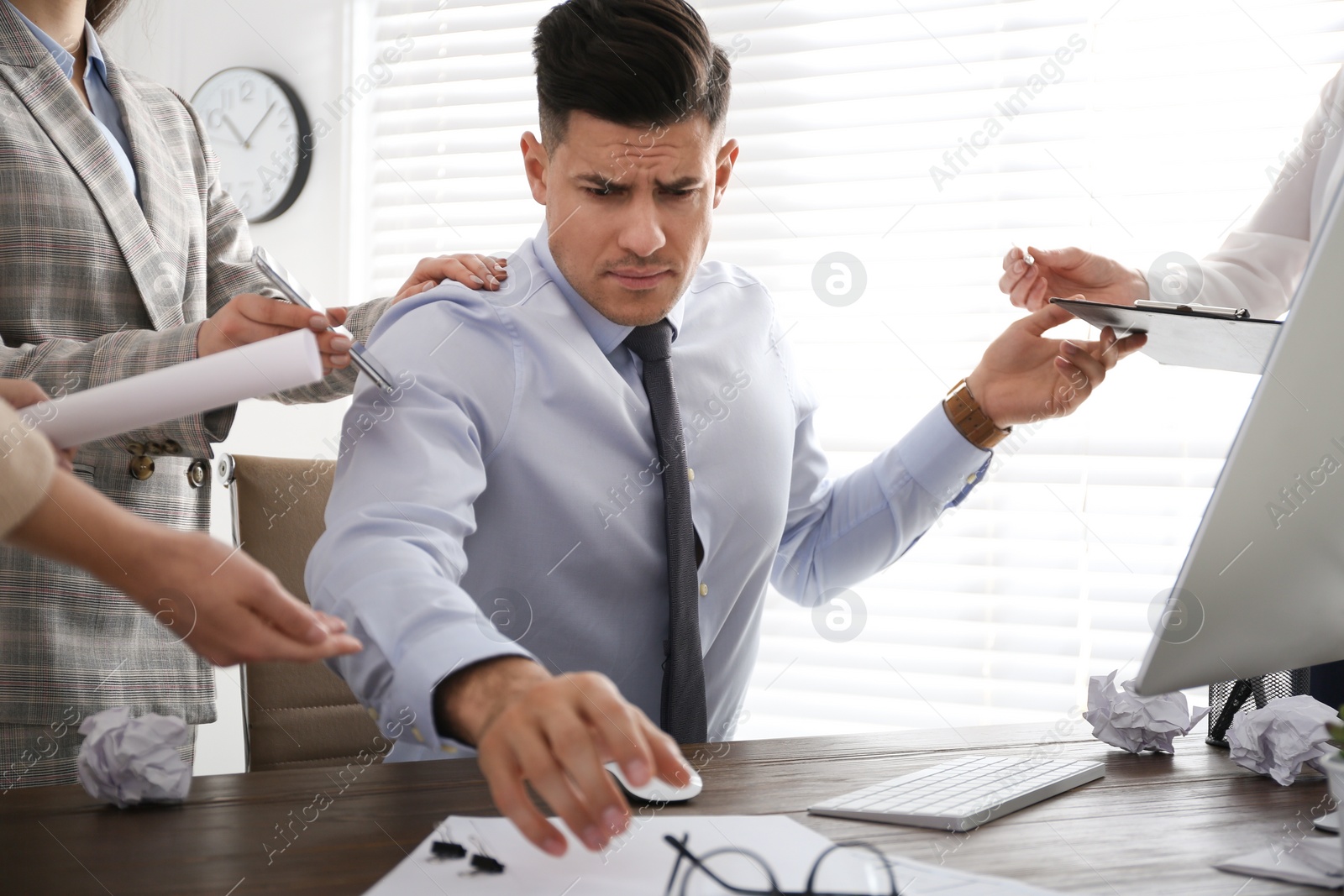 Photo of Businessman stressing out at workplace in office