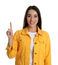 Woman in yellow jacket showing number one with her hand on white background