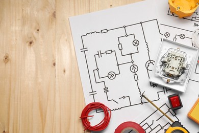 Flat lay composition with wiring diagrams on wooden table, space for text