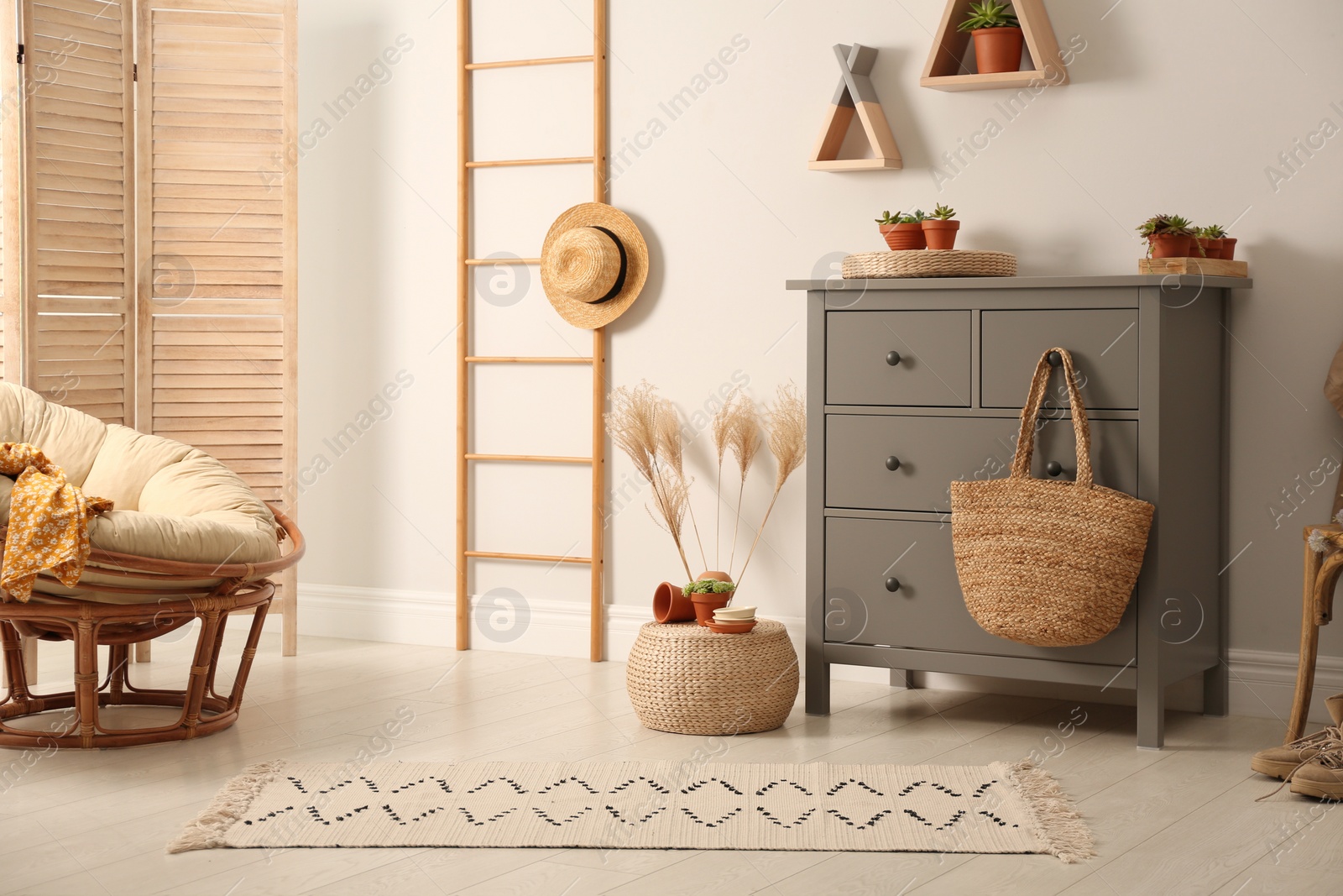 Photo of Grey chest of drawers in stylish room interior