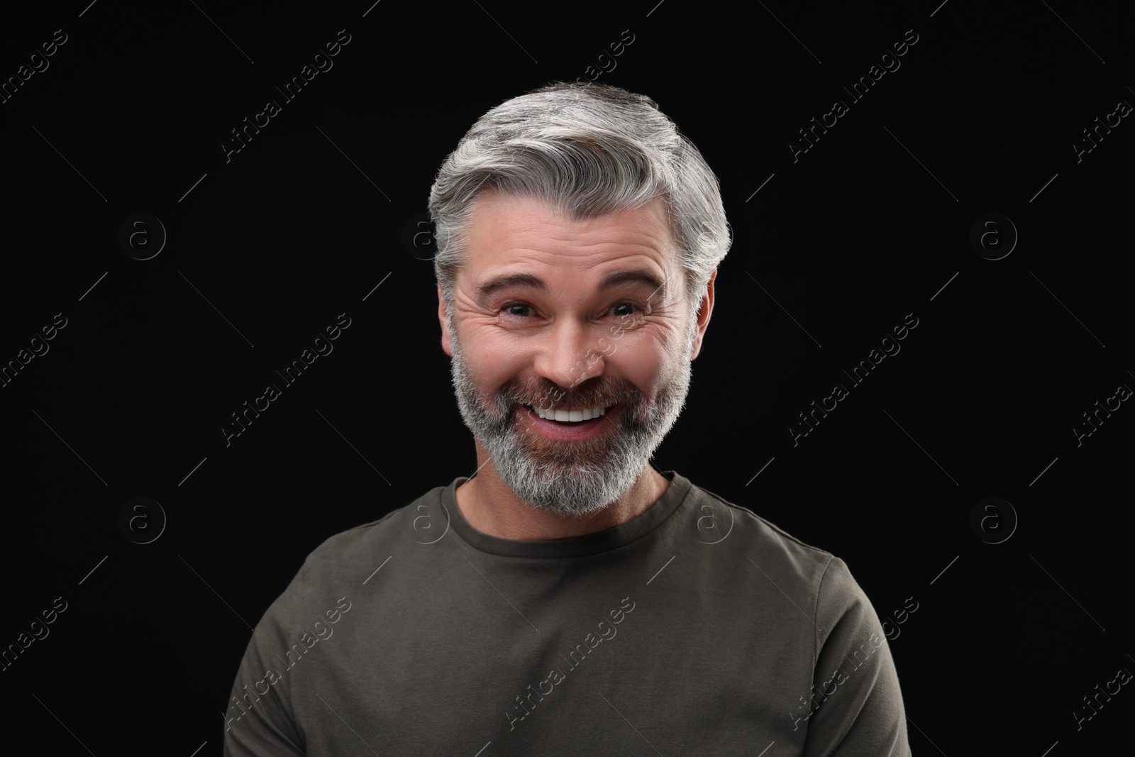 Photo of Personality concept. Portrait of happy man on black background