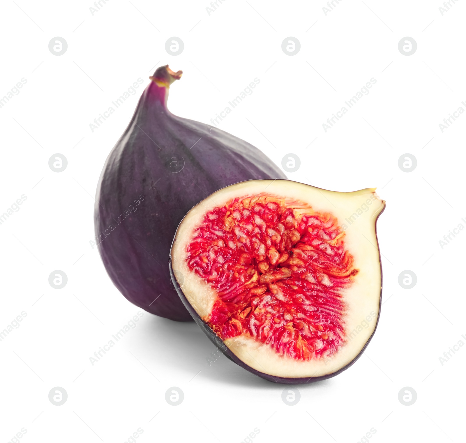 Photo of Whole and cut purple figs on white background