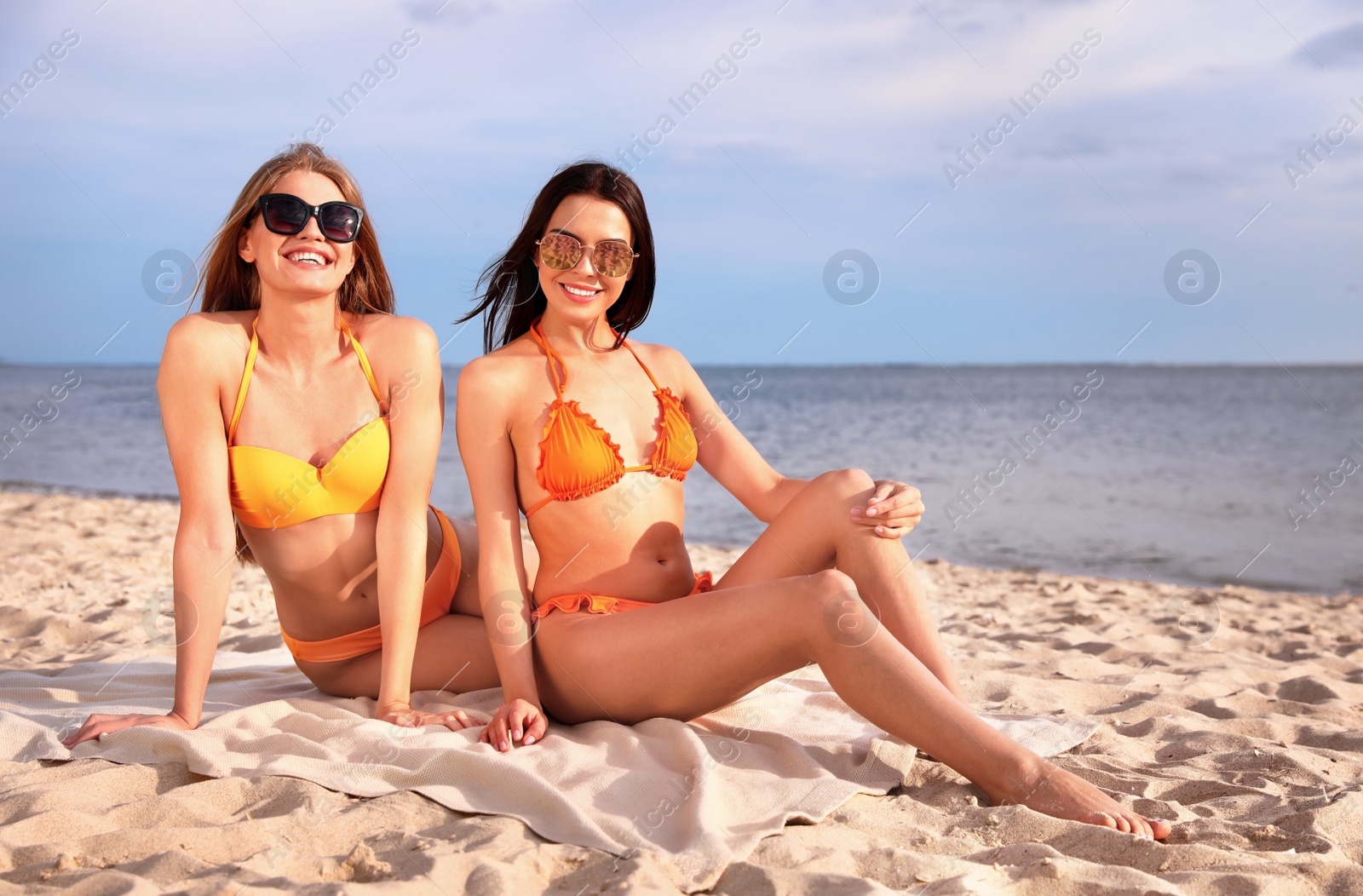 Photo of Young couple in bikini spending time together on beach