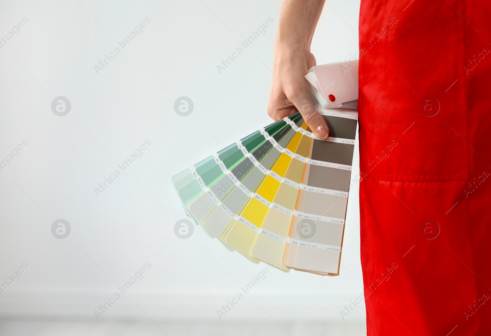 Photo of Female decorator with color palette on white background, closeup