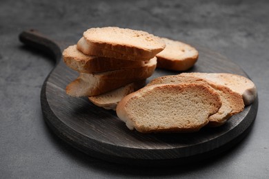 Photo of Tasty hard chuck crackers on grey table