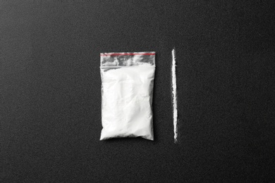 Photo of Flat lay composition with cocaine on dark background