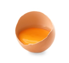 Photo of Cracked raw chicken egg with yolk on white background