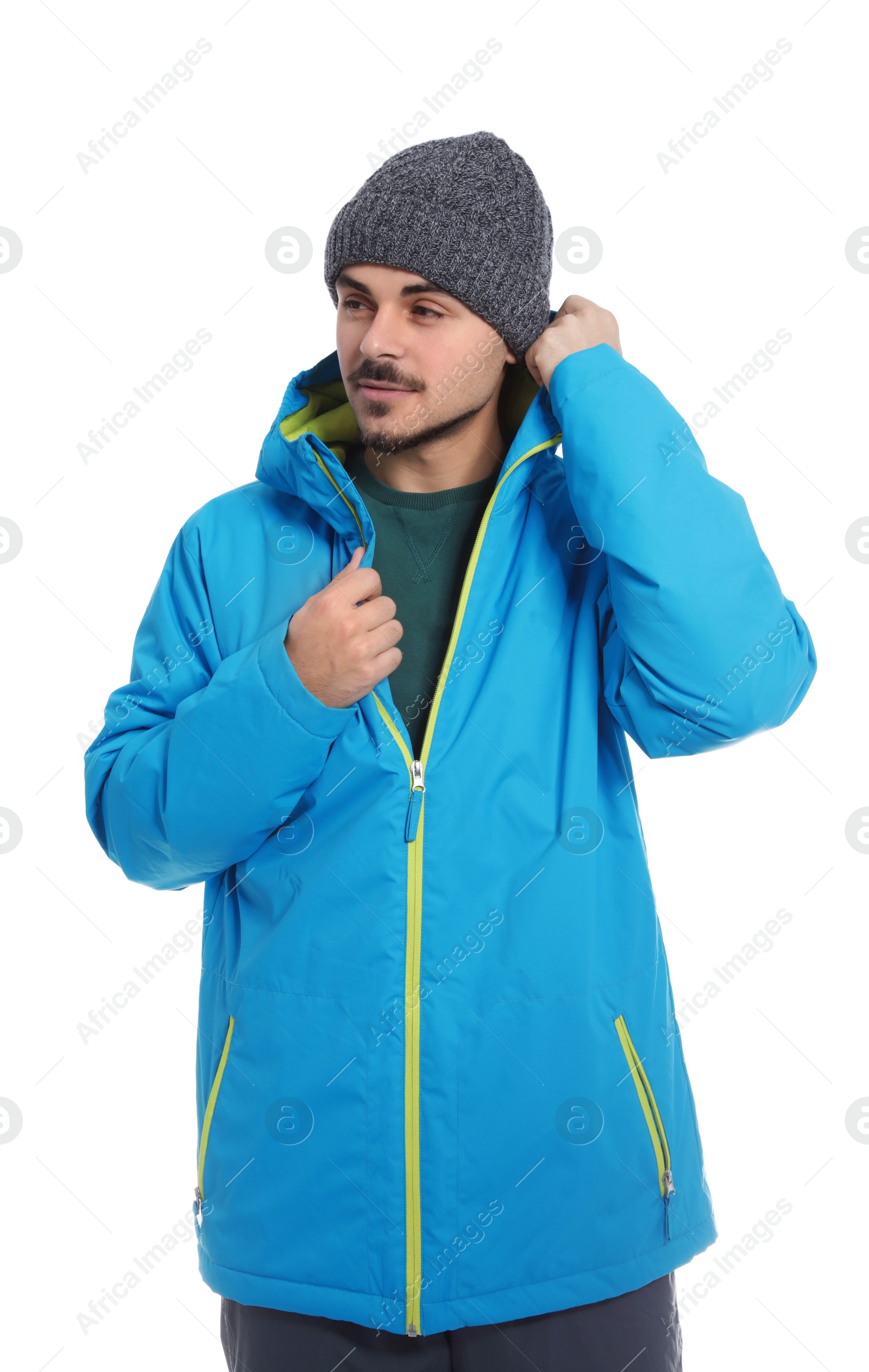 Photo of Young man wearing warm clothes on white background. Ready for winter vacation