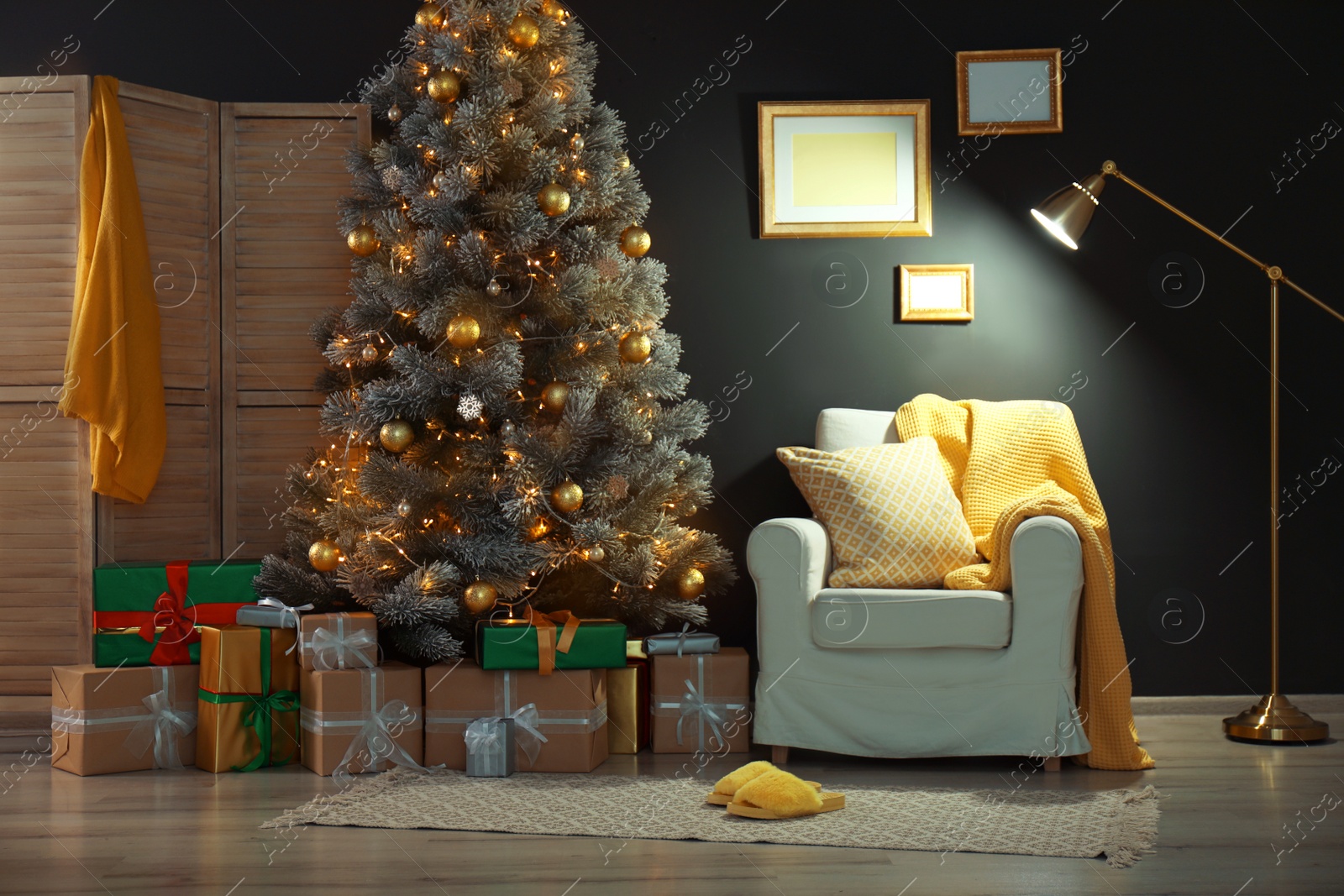 Photo of Stylish room interior with beautiful Christmas tree and gift boxes