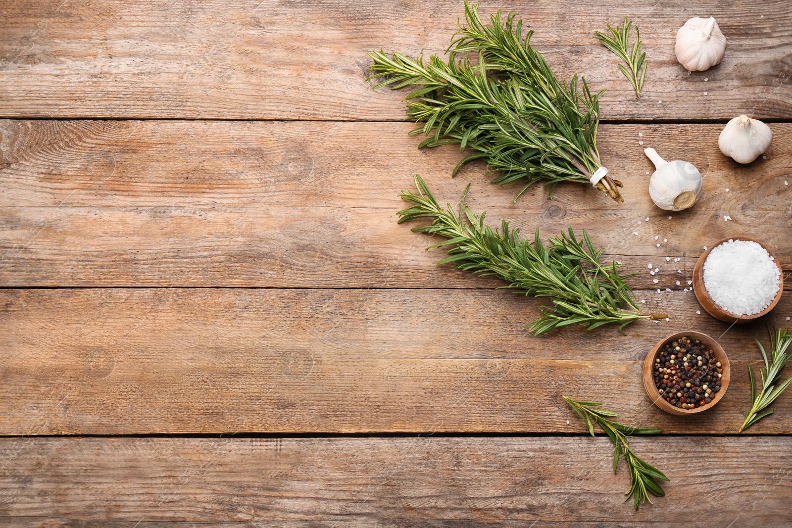 Photo of Flat lay composition with fresh rosemary on wooden table. Space for text