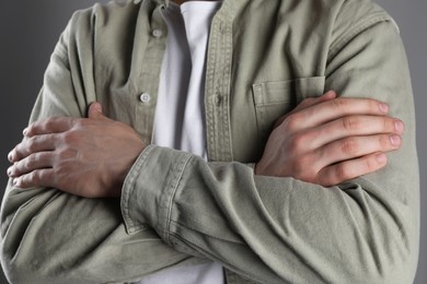 Photo of Man with space for tattoo on his hands against grey background, closeup