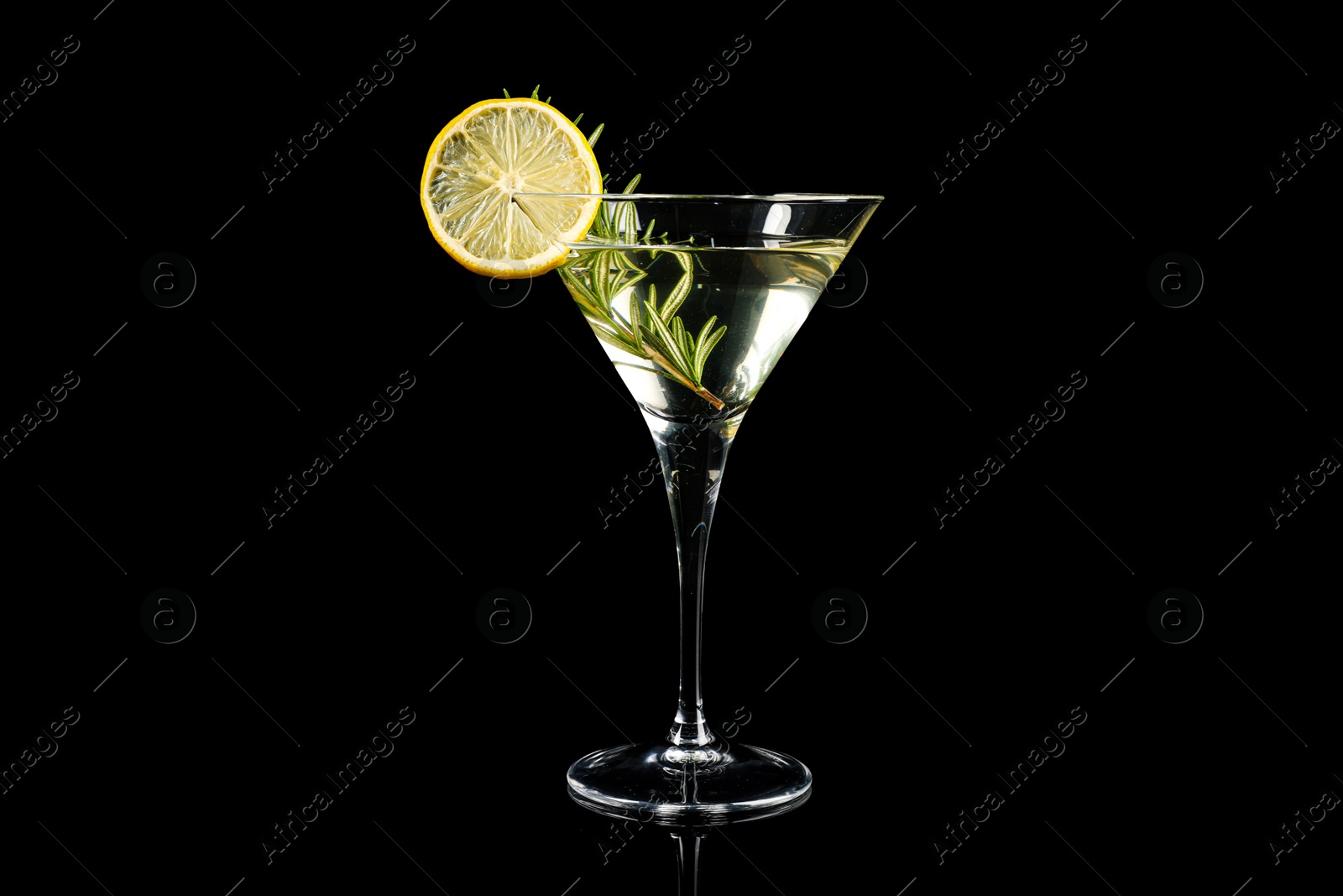 Photo of Martini cocktail with lemon slice and rosemary on black background