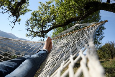 Man resting in hammock outdoors on sunny day, closeup