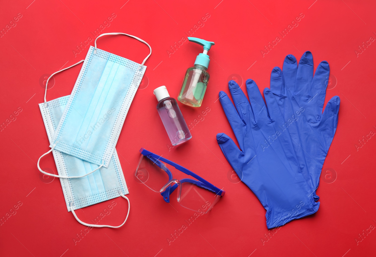 Photo of Flat lay composition with medical gloves, masks and hand sanitizers on red background