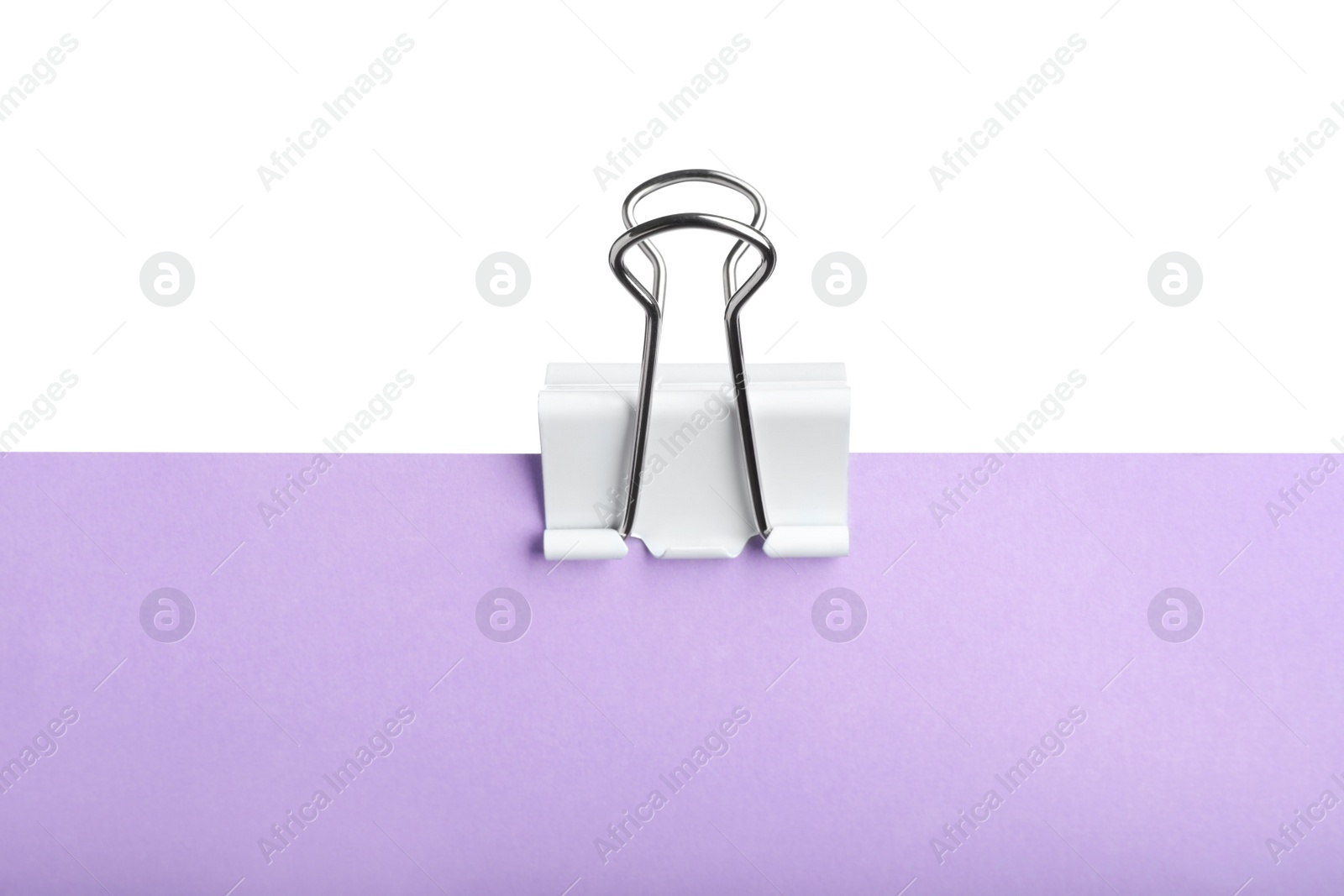 Photo of Violet paper with binder clip isolated on white