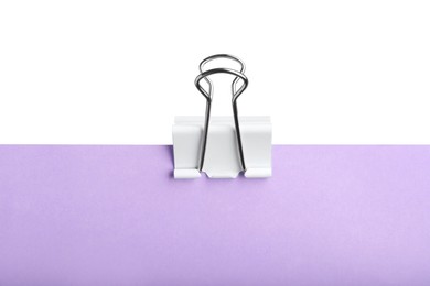 Violet paper with binder clip isolated on white