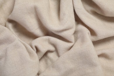 Photo of Texture of beige blanket as background, top view