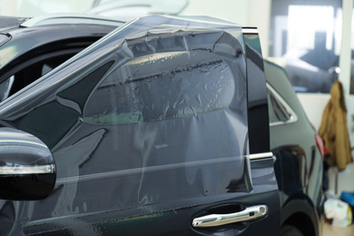 Photo of Car window covered with tinting foil, closeup