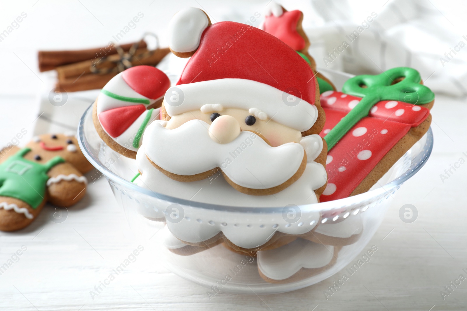 Photo of Decorated Christmas cookies on white wooden table, closeup